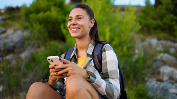 istock Beautiful girl on a hike chilling and using smartphone 2175404470