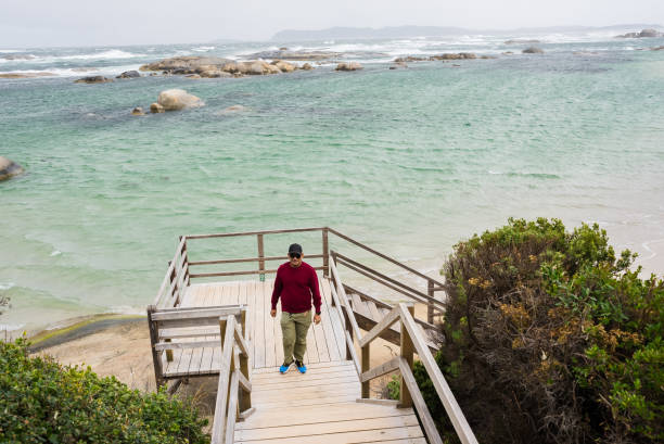 Man walking and looking out to sea