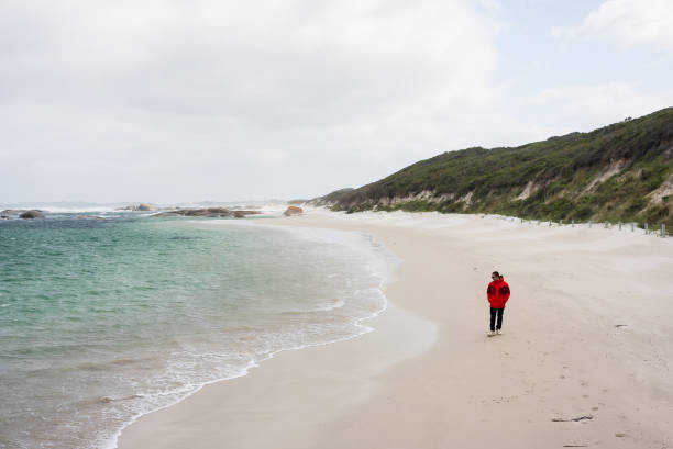 Man walking and looking out to sea