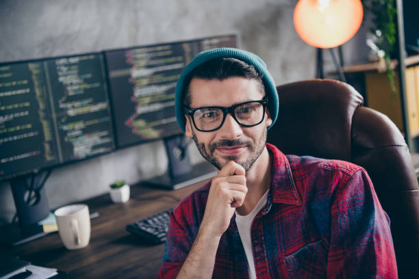istock Photo of intelligent clever coder dressed hat glasses smiling arm hand chin creating program indoors workplace workstation loft 2175407779
