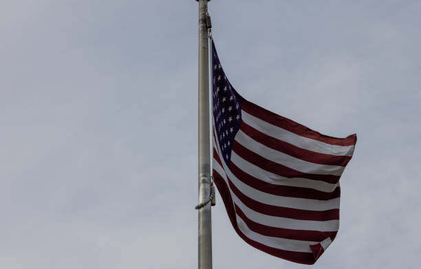 istock American Flag Waving Against a Cloudy Sky 2175407783