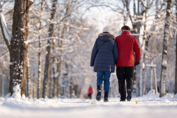 istock people walking in park on winter day with snow 2175411012