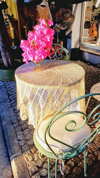 istock wrought iron chairs and lace tablecloth on the table. 2175413414