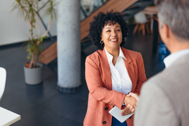 istock Confident Businesswoman Smiling During a Professional Handshake 2175417510