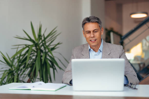 istock Business professional smiling confidently at desk with laptop 2175417578