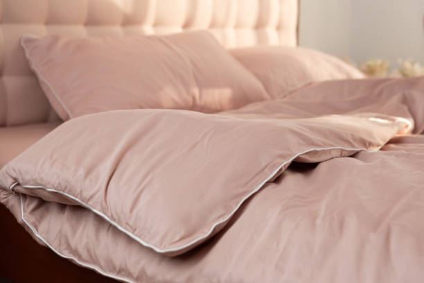 istock light beige satin bedding on the bed, pillows and blanket 2175420013