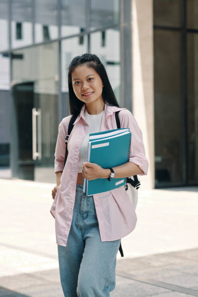 istock Student With Textbooks Standing Outdoors 2175424663