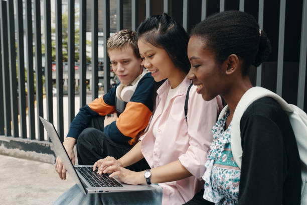 istock Students Using Laptop Together Outdoors 2175426449