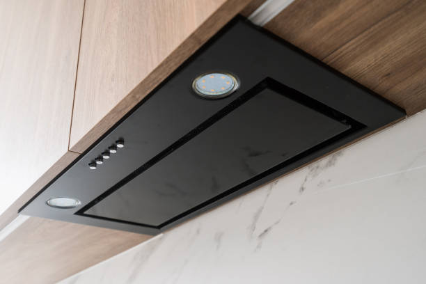 istock Modern kitchen range hood installed under wooden cabinets in a contemporary home 2175431586