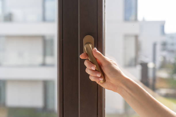 istock Hand opening a window or closed plastic door in modern house 2175433343