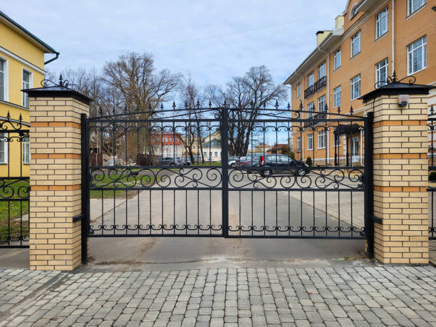 istock Beautiful new cast iron openwork gates on a cloudy autumn day 2175433478