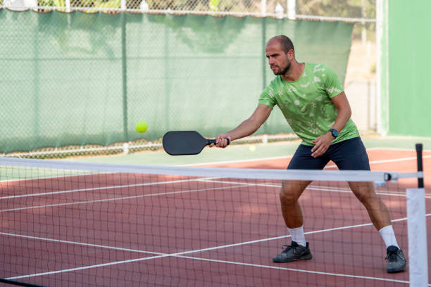 istock male with athletic body is shooting forehand on hardcourt horizontal pickleball still 2175436042