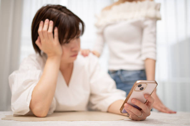 Two women looking at a smartphone
