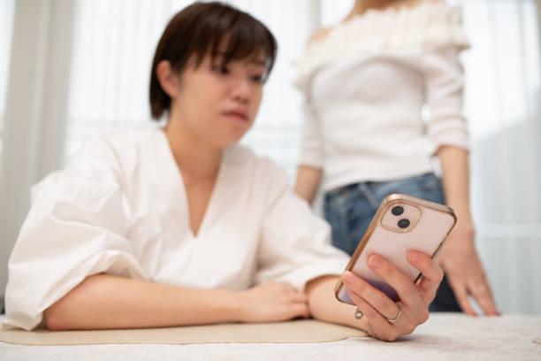 istock Two women looking at a smartphone 2175438130