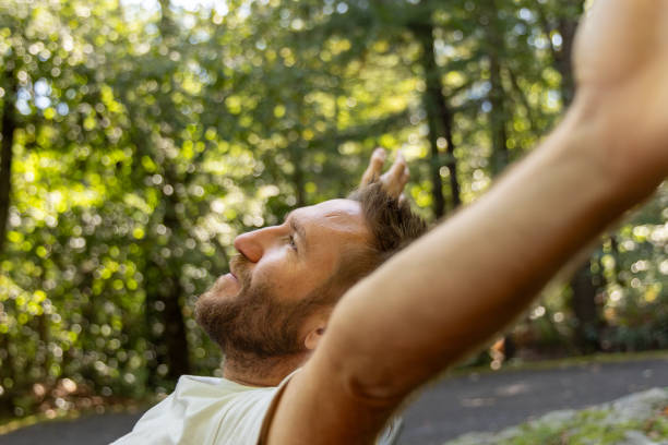 istock Man Stretching and Enjoying Nature Outdoors 2175438344