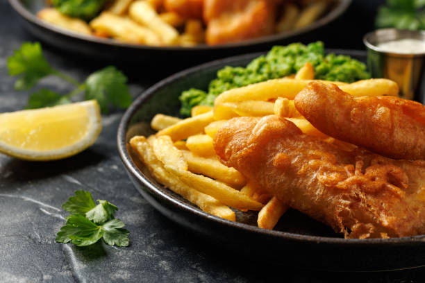 istock British Fish and chips with mashed peas, tartar and ketchup sauce. 2175438392