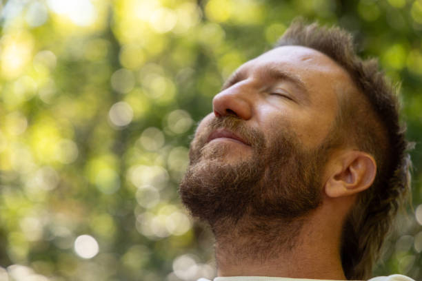 istock Man Meditating Outdoors with Eyes Closed in Nature 2175438401