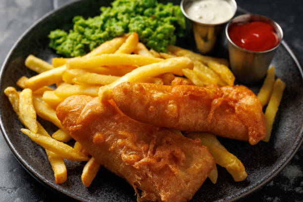 istock British Fish and chips with mashed peas, tartar and ketchup sauce. 2175438454