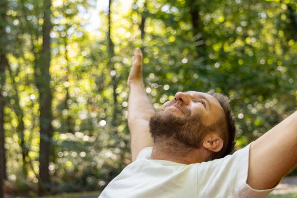 istock Man Stretching and Enjoying Nature Outdoors 2175438457