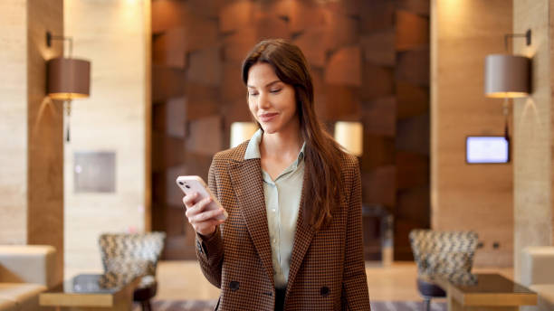 istock Beautiful businesswoman smiling and using smartphone 2175441205