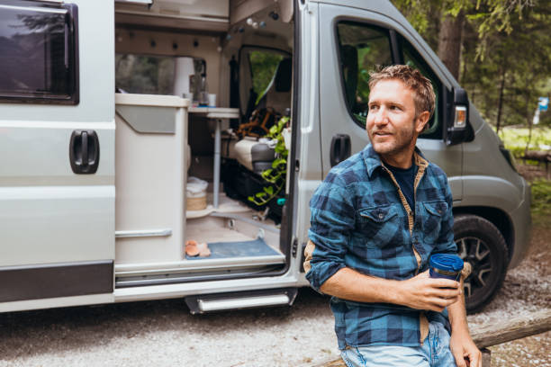 istock Man Relaxing by Camper Van with Coffee 2175446718