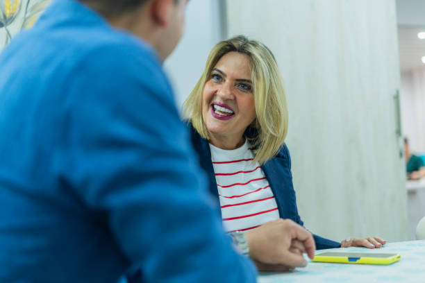 istock Advisor visits his client in the office and explains everything related to the business 2175451873