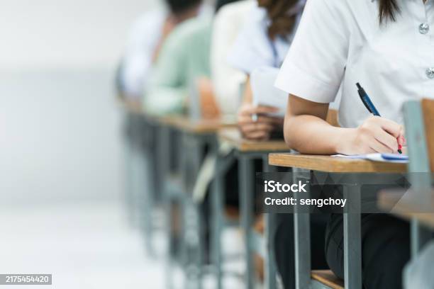 Exam Session Loading Students Taking Exam In Classroom Setting Students In Uniforms Are ...