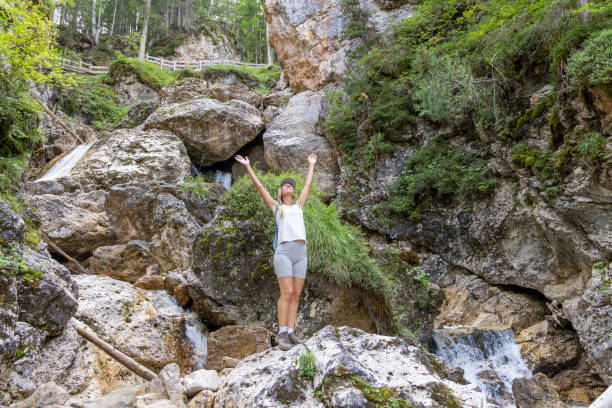 istock Adventurous Hiker On Rocky Terrain by Waterfall 2175456735