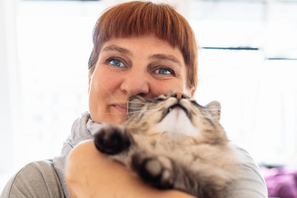 istock woman hugging fluffy gray cat 2175459470