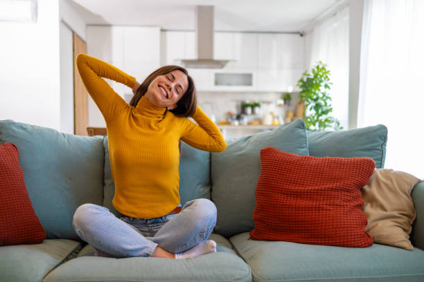 istock Relaxed Woman Enjoying A Peaceful Moment At Home On Sofa 2175459744