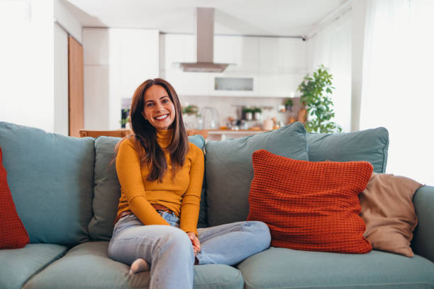 istock Smiling Woman Relaxing on a Comfortable Sofa at Home 2175459787