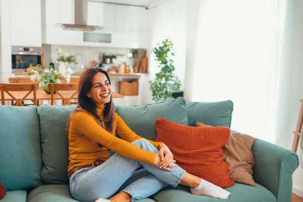 istock Smiling Woman Relaxing on a Comfortable Sofa at Home 2175459796