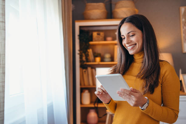 Smiling Woman Using Tablet in Cozy Living Room Setting