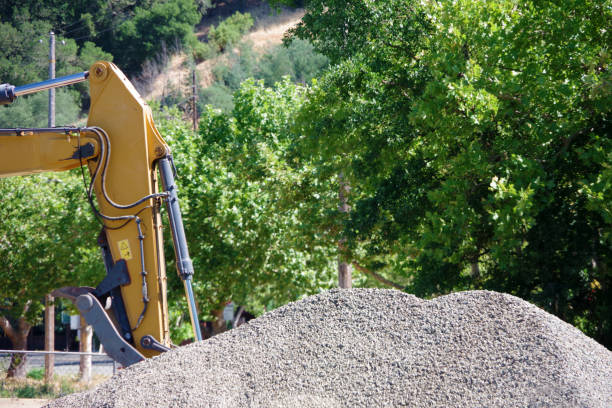 Excavator at a large pile of gravel