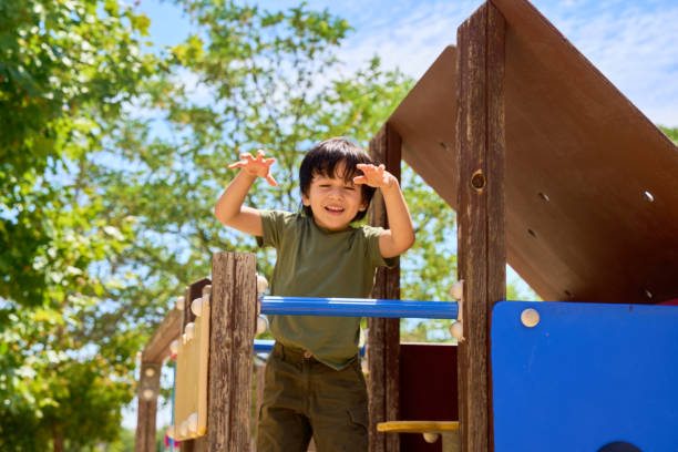 istock child playing in an outdoor playground 2175465892