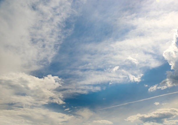 Beautiful cirrus clouds on a bright sunny day against the blue sky.