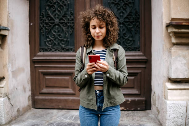 istock Beautiful young woman using smart phone 2175485715