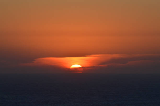 istock Sunset over the sea trough the clouds 2175486658
