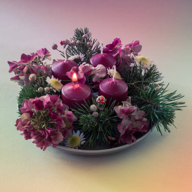 istock advent wreath with four red candles, 1 candle burning, purple tone 2175489539