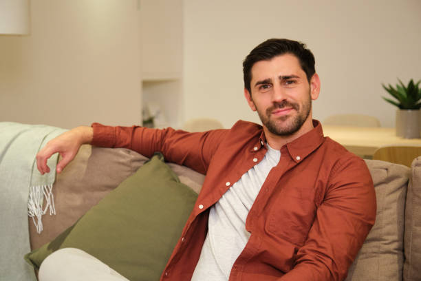 istock Handsome man relaxing on comfortable sofa at home 2175493137