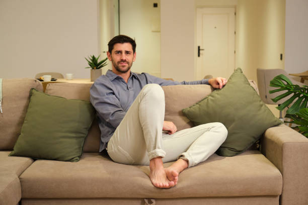 istock Handsome man relaxing on comfortable sofa at home 2175494224