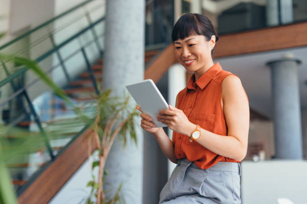 istock Smiling Japanese Professional Woman Using Tablet in Modern Office Setting 2175497164