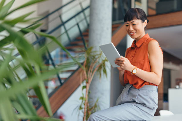 istock Smiling Japanese Professional Woman Using Tablet in Modern Office Setting 2175497227
