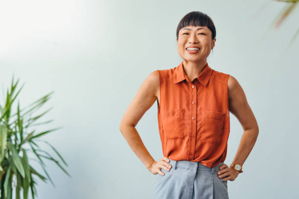 istock Confident ASIAN Woman Smiling in Bright Office Environment 2175497303