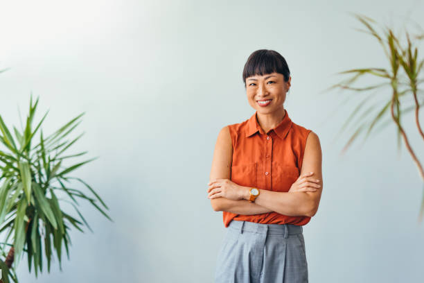 istock Confident ASIAN Woman Smiling in Bright Office Environment 2175497336