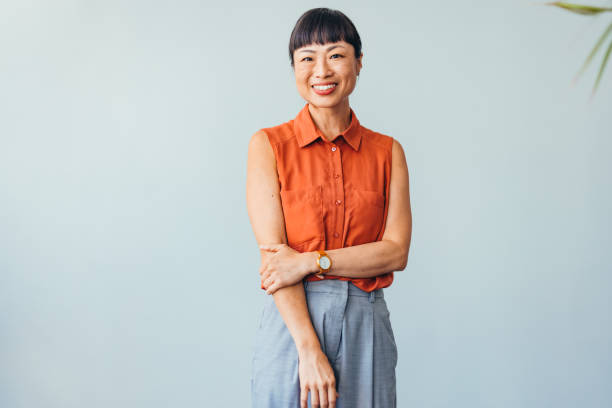 istock Confident ASIAN Woman Smiling in Bright Office Environment 2175497350