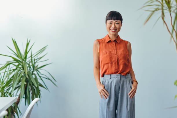 istock Confident ASIAN Woman Smiling in Bright Office Environment 2175497355