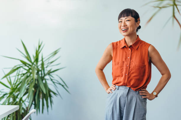 istock Confident ASIAN Woman Smiling in Bright Office Environment 2175497357