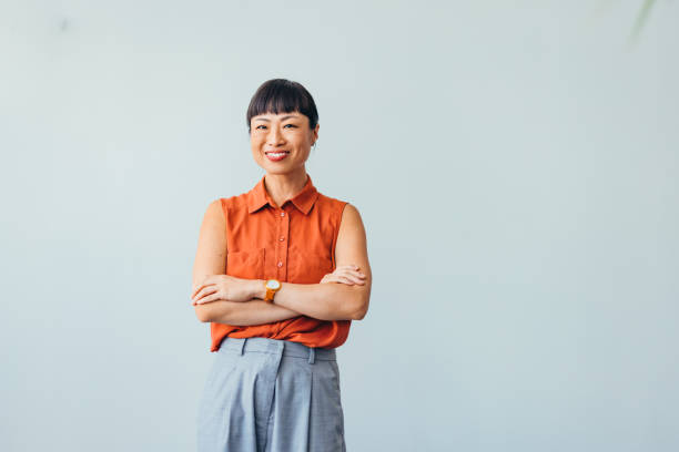 istock Confident ASIAN Woman Smiling in Bright Office Environment 2175497360