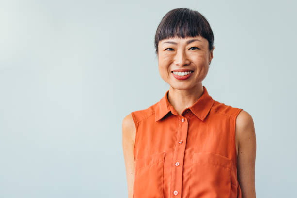 istock Confident ASIAN Woman Smiling in Bright Office Environment 2175497387